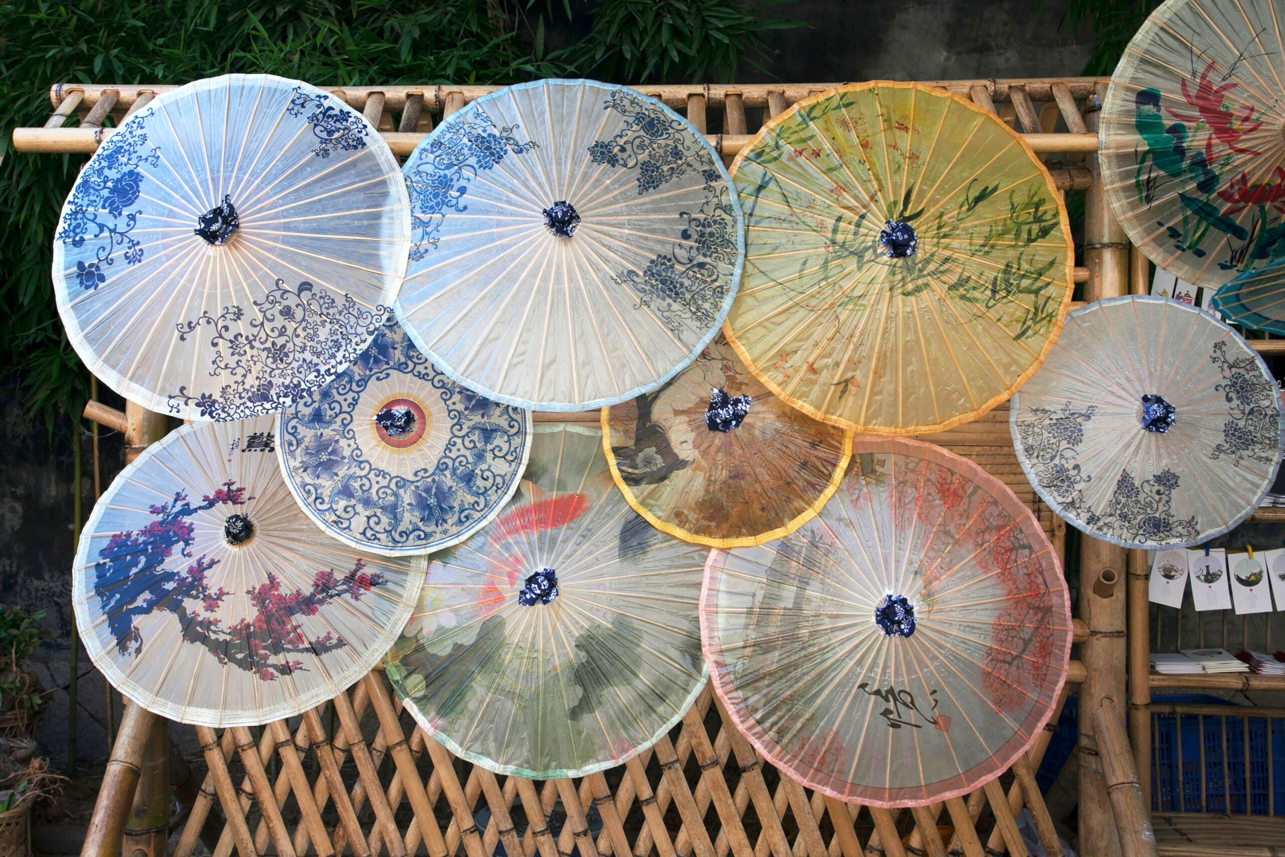 Beautifully crafted traditional umbrellas showcased on bamboo frame in Fuzhou, China.