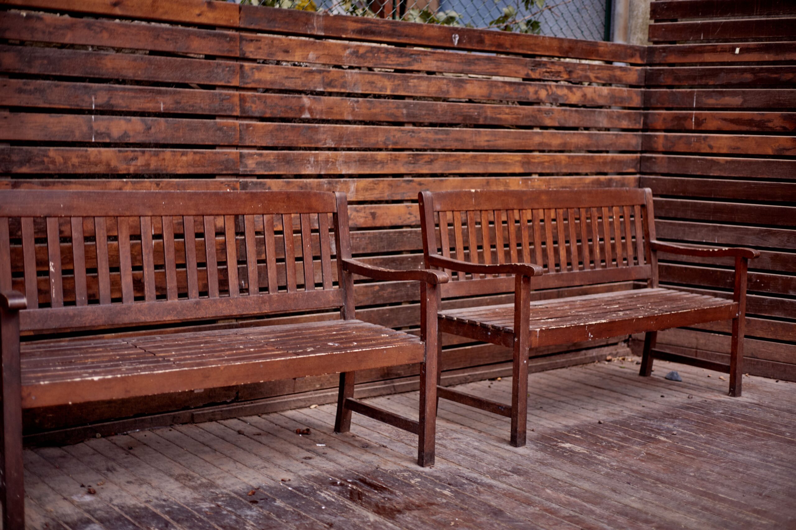 Two rustic wooden benches in an outdoor patio area, İstanbul, Türkiye.